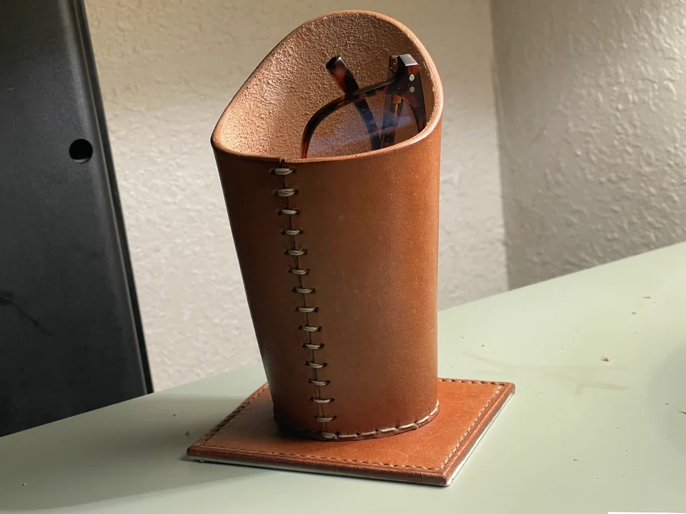 Front view of the leather eyeglass holder on a cutting mat.