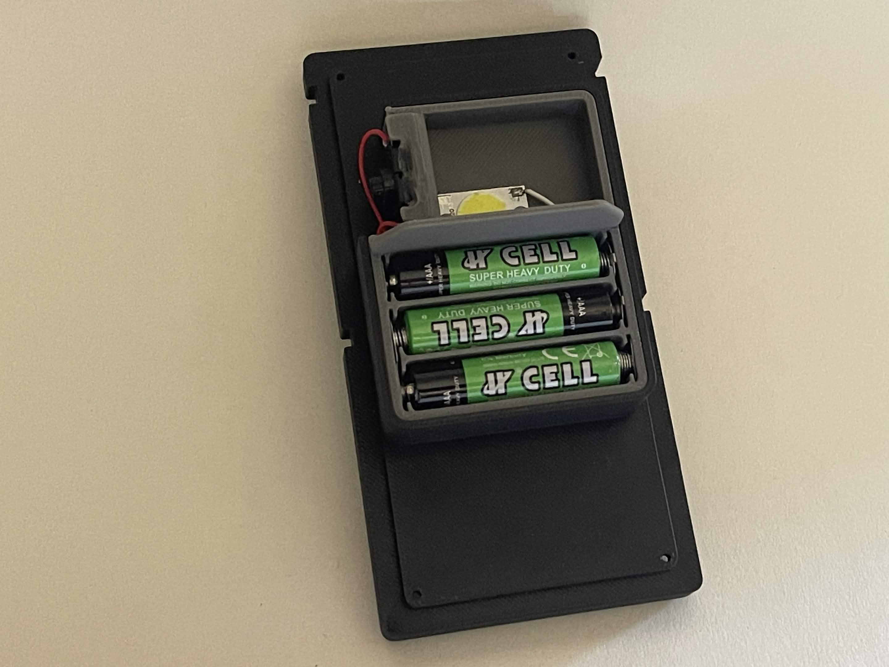 Interior of the completed radio belt box showing battery tray and lighting hardware.