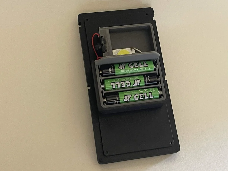 Interior of the completed radio belt box showing battery tray and lighting hardware.