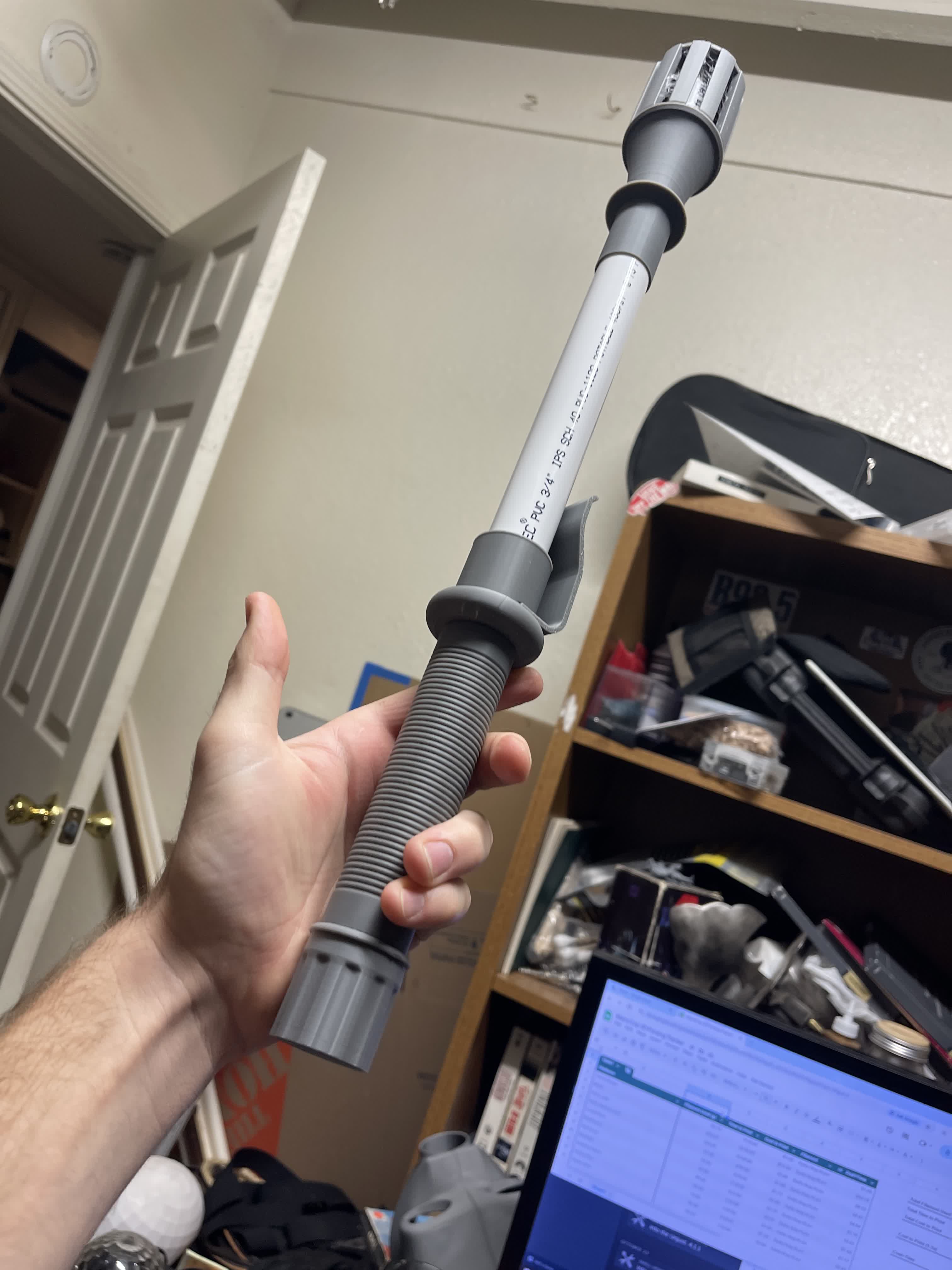 Unpainted early Metrocop stunstick build held in hand.