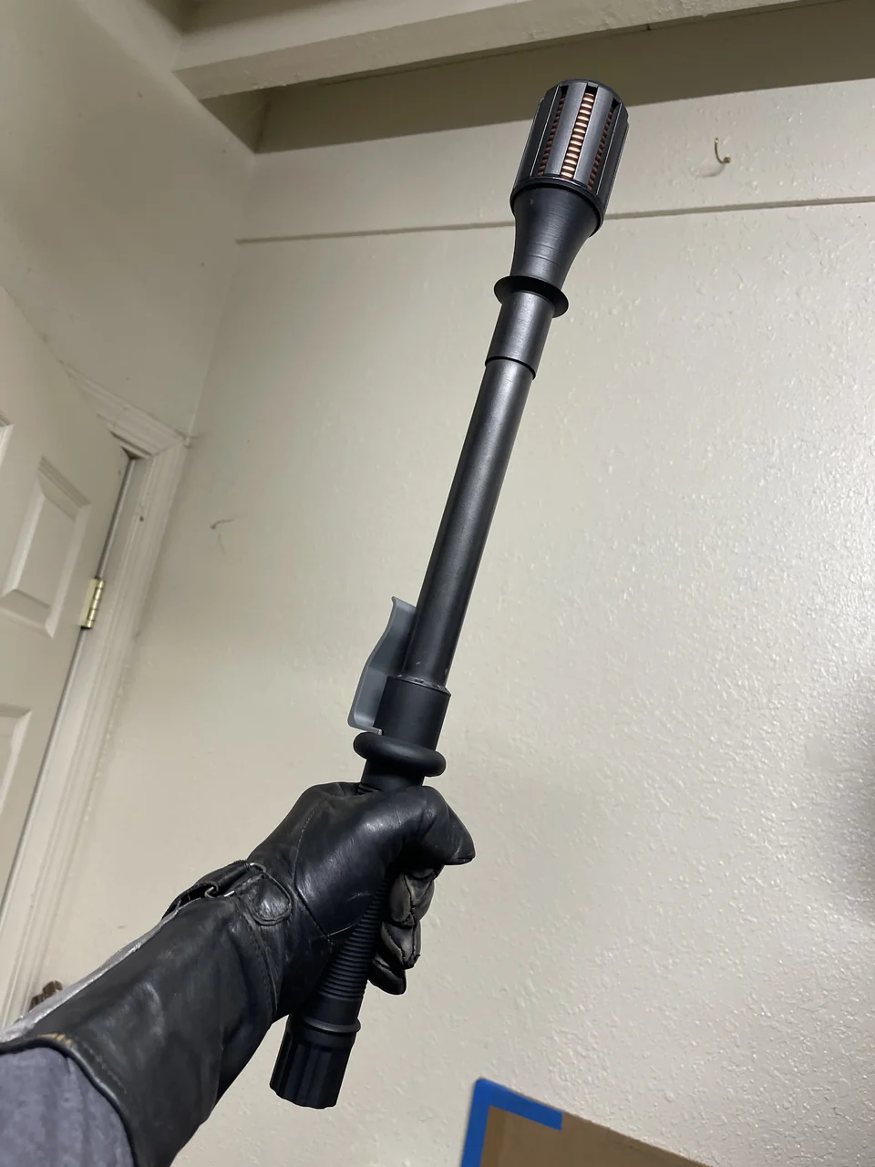 Black fabricated stunstick prop held upright